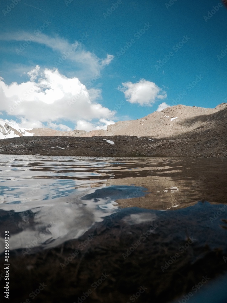 landscape of snowy mountains with a lake in the sierra nevada in spain