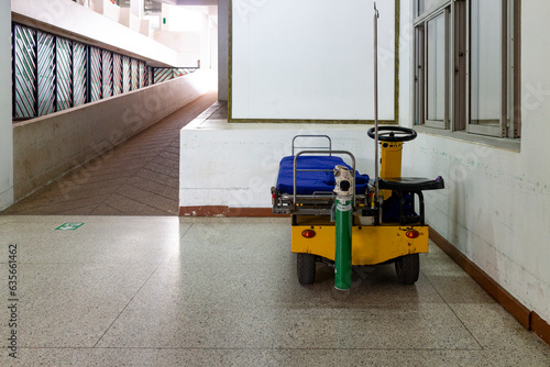 Wheelchair EV, equipped with bed and oxygen tank for transporting patients within the hospital building