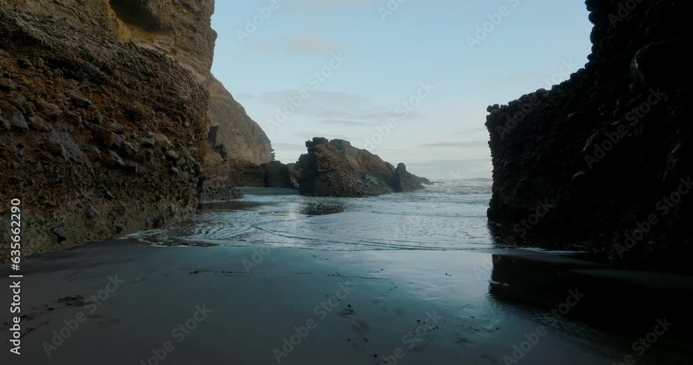 Aerial: Calm rocky coastline at sunset. Auckland, New Zealand Aerial: Calm rocky coastline at sunset. Auckland, New Zealand