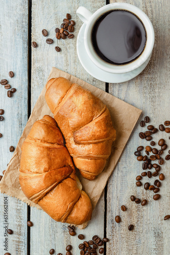 White coffee cup, croissants on wood table background. Flat lay. Top view. sweet baking dessert for coffee.
