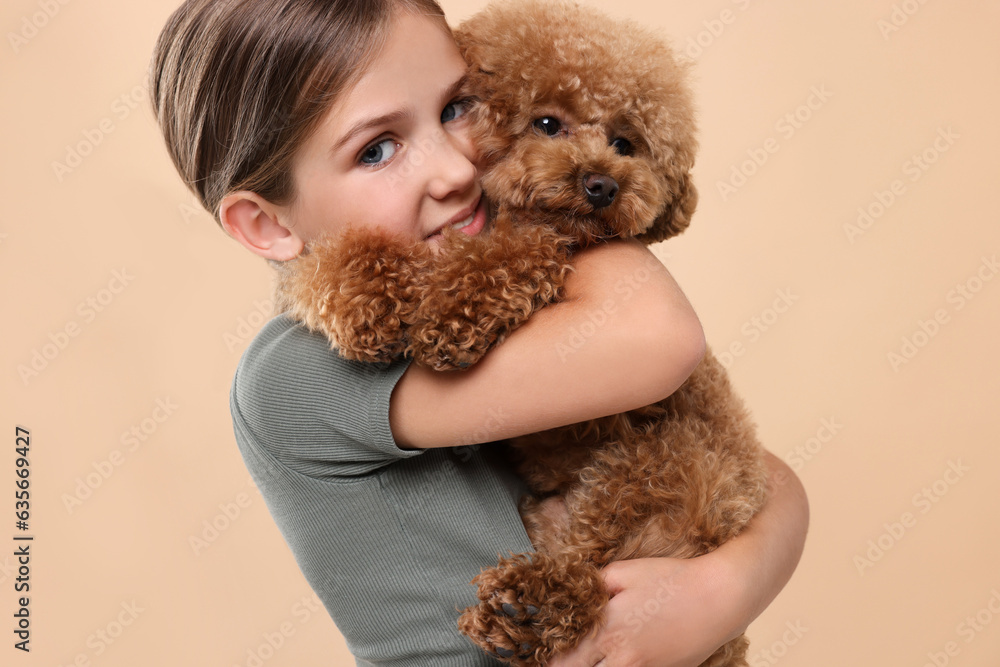 Little child with cute puppy on beige background. Lovely pet Little child with cute puppy on beige background. Lovely pet