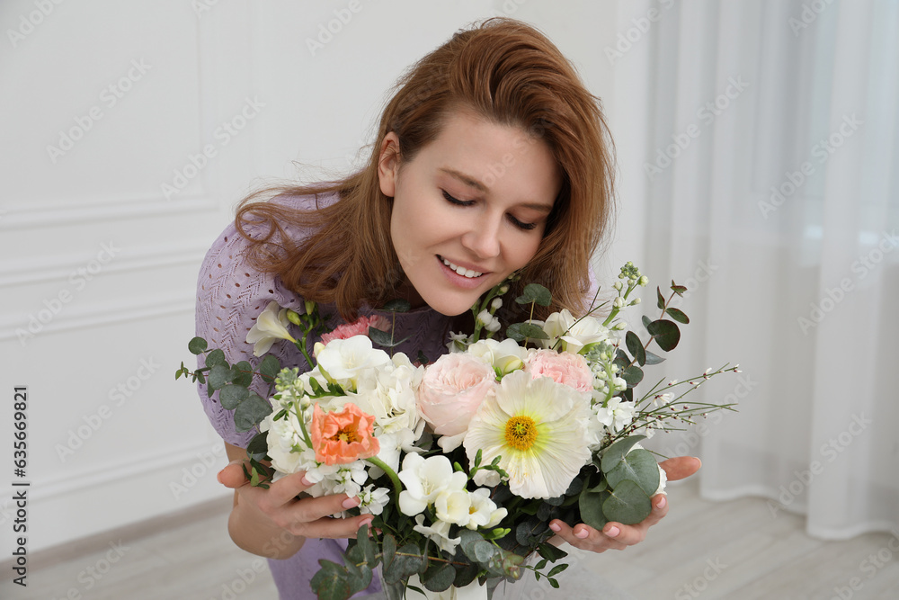 Beautiful woman with bouquet of flowers indoors Beautiful woman with bouquet of flowers indoors