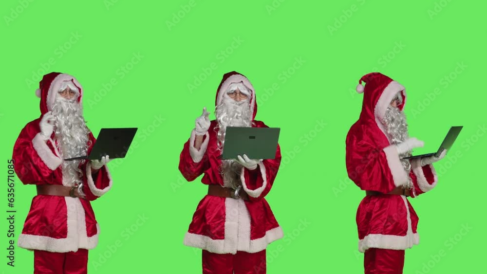 Cool santa claus character with laptop, checking xmas naughty or nice list of children against greenscreen backdrop. Modern person portraying father christmas using wireless pc. Cool santa claus character with laptop, checking xmas naughty or nice list of children against greenscreen backdrop. Modern person portraying father christmas using wireless pc.