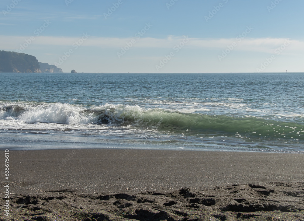 a close view of chilean shore coastal beach with tidal waves on summer sunny midday