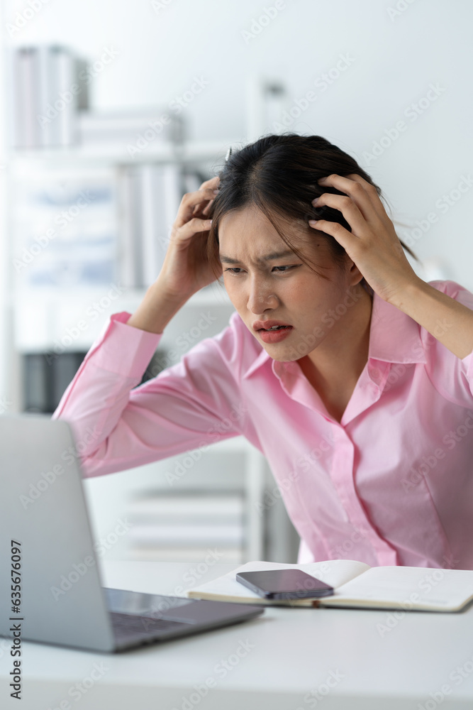 Tired Asian businesswoman, headache, stressed, sleepy and bored from sitting at a table for a long time and have office syndrome. Tired Asian businesswoman, headache, stressed, sleepy and bored from sitting at a table for a long time and have office syndrome.