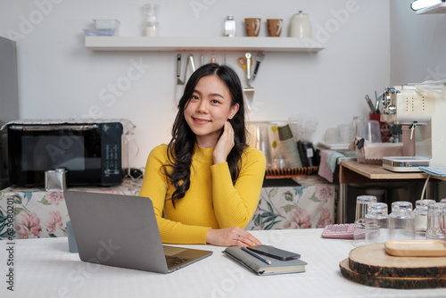 Asian young woman use laptop to work at home