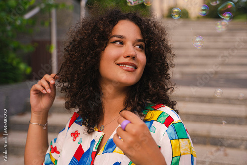 Young stylish female portrait, smiling outdoors