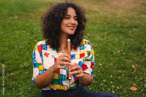 Young woman playing flute outdoors