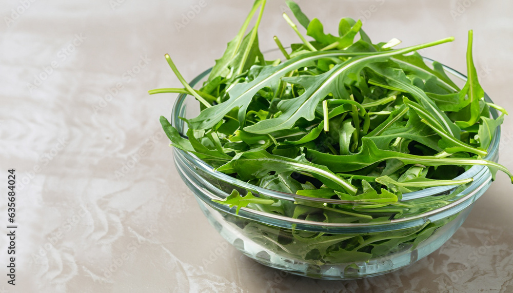 Rocket salad or arugula leaves in glass bowl, horizontal Rocket salad or arugula leaves in glass bowl, horizontal