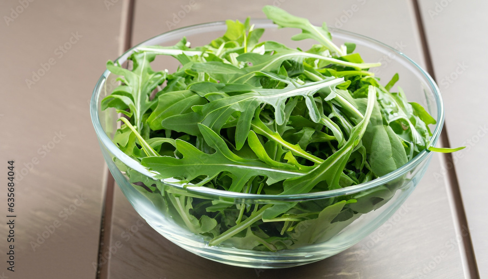 Rocket salad or arugula leaves in glass bowl, horizontal Rocket salad or arugula leaves in glass bowl, horizontal