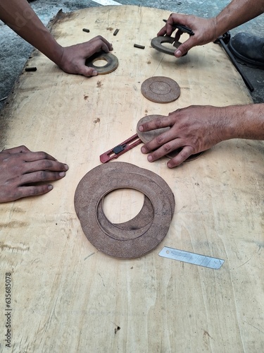 Jakarta, Indonesia, 15 July 2023; The process of making packing gaskets on 20kv bushings and transformer manholes photo