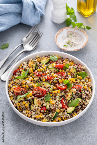 Warm quinoa salad with tomatoes, corn and zucchini