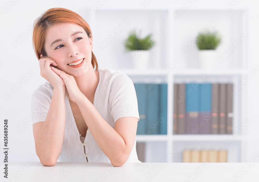 Portrait of cheerful woman sitting and thinking in living room Portrait of cheerful woman sitting and thinking in living room