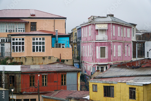 Simple yet vibrant colored houses in Valparaíso during a cloudy day.