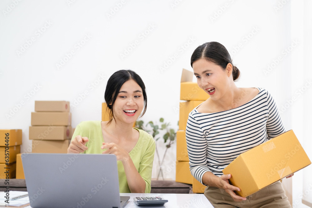 Asian businesspeople working in home office. They are happy and success with their online store. Concept of freelancer startup and online business. Asian businesspeople working in home office. They are happy and success with their online store. Concept of freelancer startup and online business.
