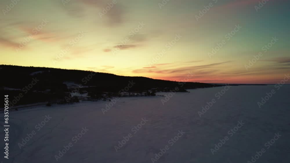 Flying drone above a frozen lake in canada at golden hour Flying drone above a frozen lake in canada at golden hour