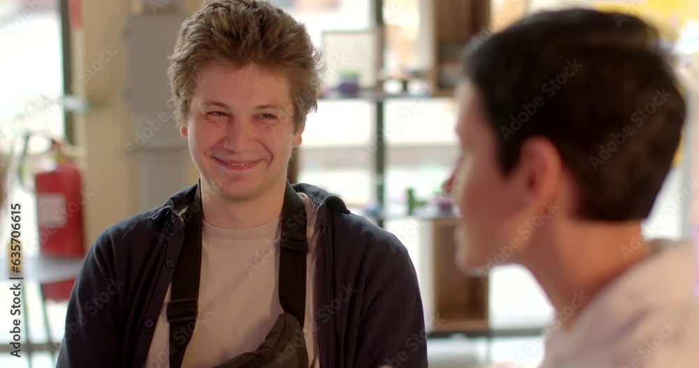 Portrait of a young man during a conversation. Involuntary laughter or smiling as psychological defense mechanism. Coping mechanism helps individuals navigate uncomfortable or distressing topics. Portrait of a young man during a conversation. Involuntary laughter or smiling as psychological defense mechanism. Coping mechanism helps individuals navigate uncomfortable or distressing topics.