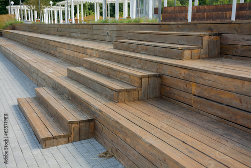 old wooden steps of brown color in the city garden
