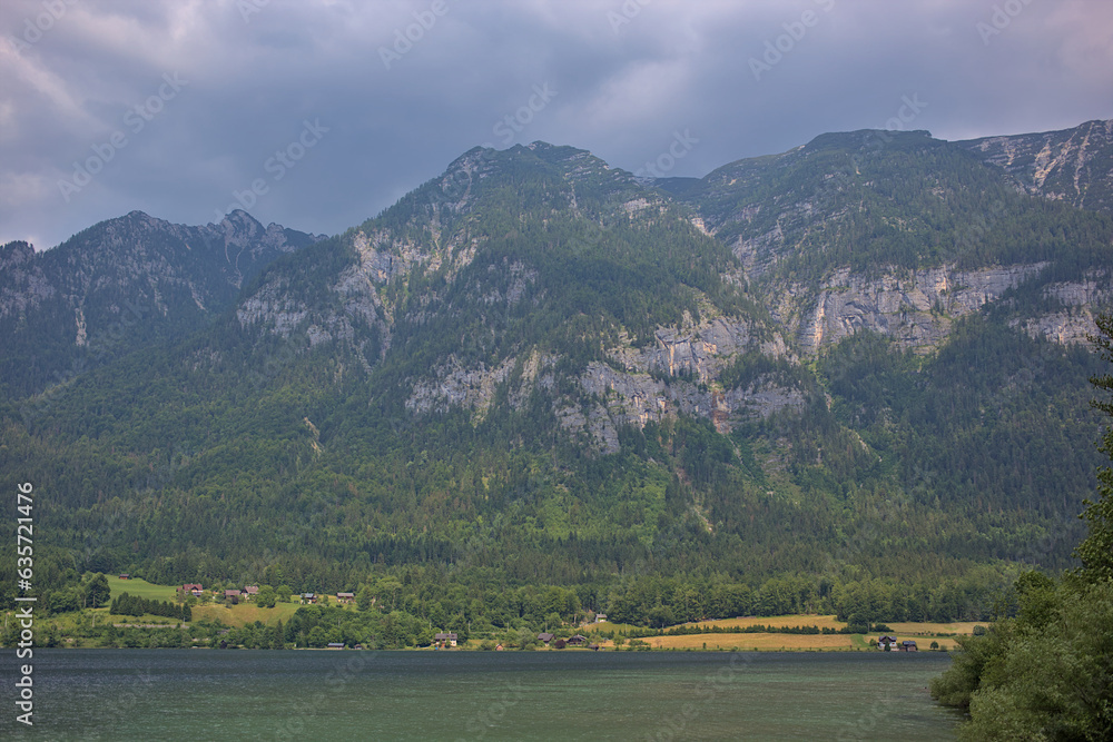 Beautiful foggy and cloudy landscape with a lake and mountains in summer. Natural colorful background. Lake Traunsee is very popular as a health and holiday resort. Gmundnerberg, Upper Austria.