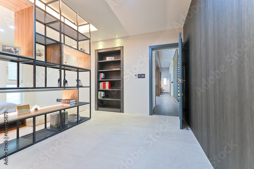 фотографія A bookshelf was placed in the center of the bedroom to separate space from space