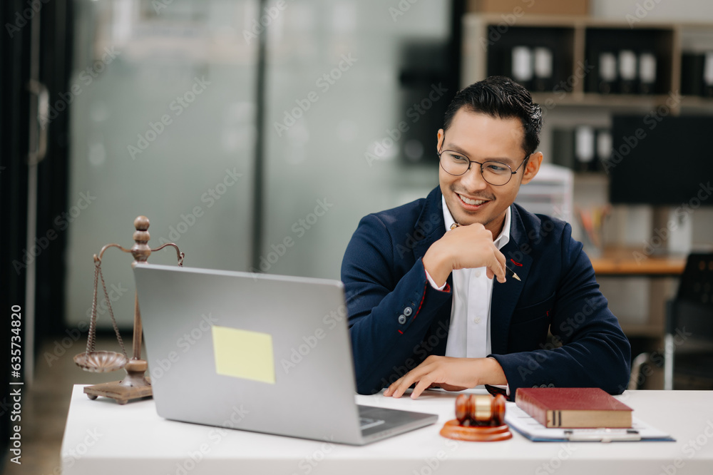 justice and law concept .Asian Male judge in a courtroom on table and Counselor working in modern office.. justice and law concept .Asian Male judge in a courtroom on table and Counselor working in modern office..