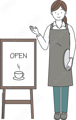 カフェの看板の横に立つ女性店員