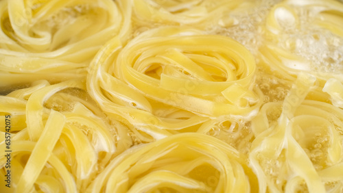 Cooking pasta Tagliatelle. Pasta boiled in boiling hot water on pan