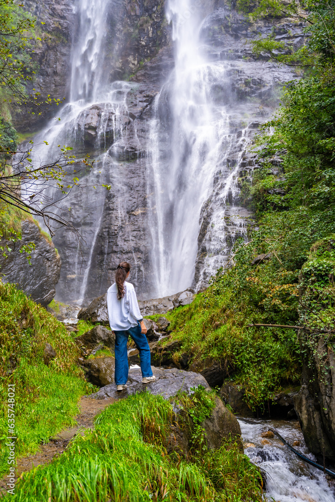 Young woman near waterfall in San Pietro town in Italy Young woman near waterfall in San Pietro town in Italy