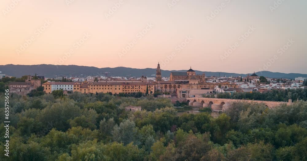 Sunset panoramic view day to night timelapse of Cordoba city Mezquita Mosque cathedral and roman bridge during summer Sunset panoramic view day to night timelapse of Cordoba city Mezquita Mosque cathedral and roman bridge during summer