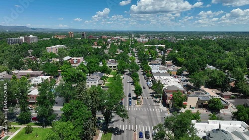 Wide shot of Fort Collins, Colorado during summer. Beautiful blue sky and clouds over skyline and neighborhoods.