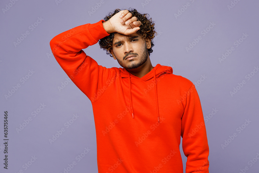 Young sad Indian man in red orange hoody casual clothes put hand on forehead suffer from headache look camera isolated on plain pastel light purple color background studio portrait Lifestyle concept Young sad Indian man in red orange hoody casual clothes put hand on forehead suffer from headache look camera isolated on plain pastel light purple color background studio portrait Lifestyle concept