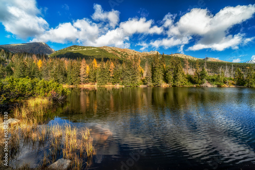 Fototapeta Naklejka Na Ścianę i Meble -  Mountain lake called Jamske pleso in autumn colors with peak Krivan at background. Slovakia