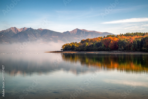 Long exposure autumn landscape. Colorful autumn leaves on trees on lake Liptovska Mara, Slovakia