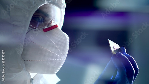 Engineer man in sterile suit is holding Microchip with symbols in modern design factory , futuristic and artificial intelligence concept photo