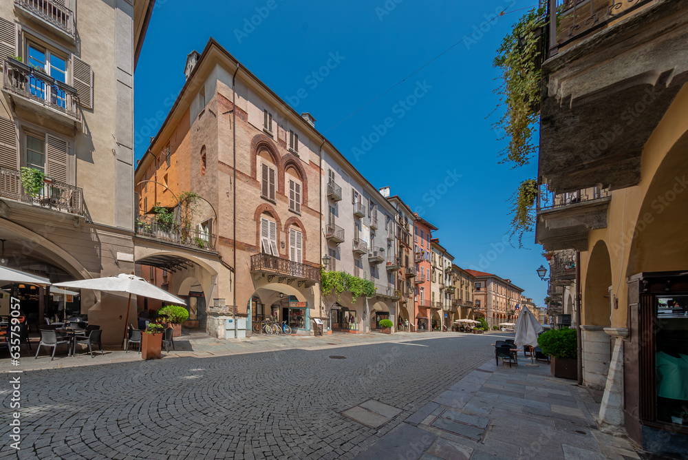 Cuneo, Piedmont, Italy - August 16, 2023: Cityscape on Roma Street main pedestrian cobblestone street with Ancient buildings decorated and with arcade in historic center