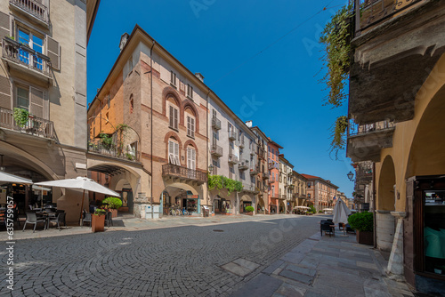 Cuneo, Piedmont, Italy - August 16, 2023: Cityscape on Roma Street main pedestrian cobblestone street with Ancient buildings decorated and with arcade in historic center