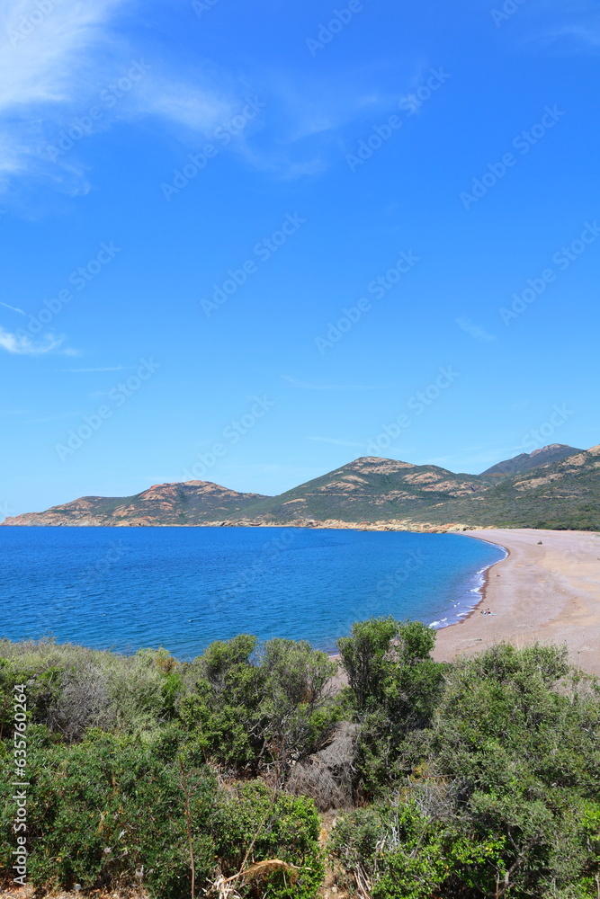 Panoramic view of the black sands of Galéria beach, turquoise Mediterranean sea and the Fango river in Corsica
