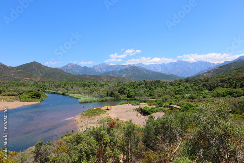 Panoramic view of the black sands of Galéria beach, turquoise Mediterranean sea and the Fango river in Corsica