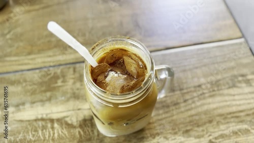 dirty iced chai latte in a mason jar on table top, cinnamon, cacao, chai, latte, tea, delicious, treat yourself, food concept, cheatday, sweet tooth, straw, chai latte, chai drink. photo
