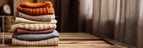 Autumn warm stack of sweaters winter background with a place for text