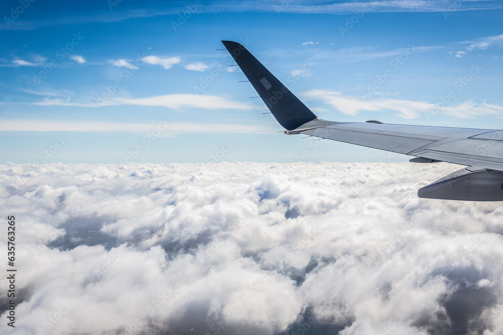 Clouds and plane wing, view from window plane Clouds and plane wing, view from window plane