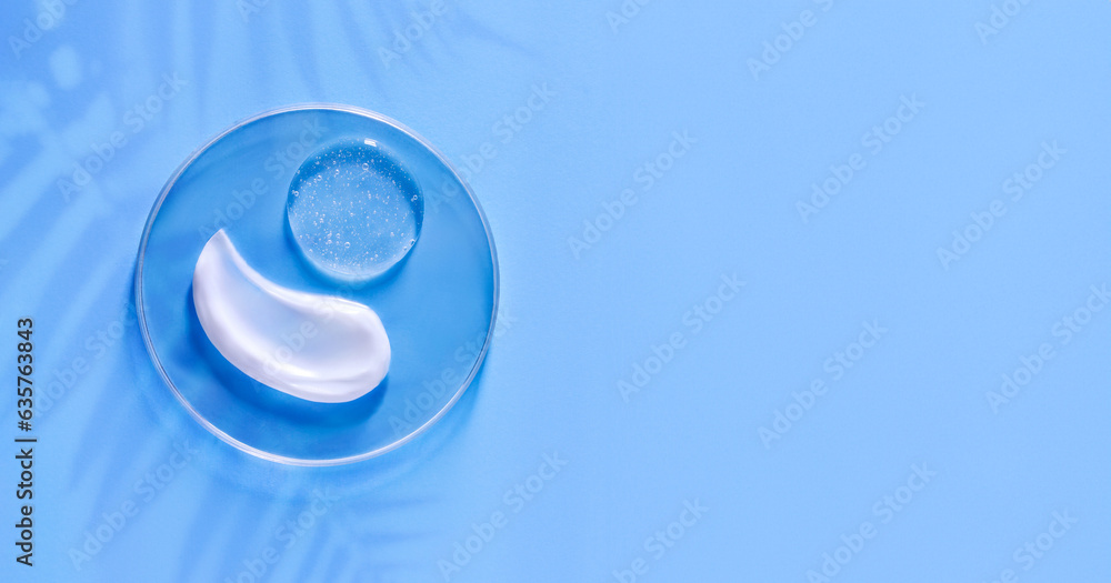 smear of cream round transparent drop of transparent gel serum in a petri dish on a blue background smear of cream round transparent drop of transparent gel serum in a petri dish on a blue background