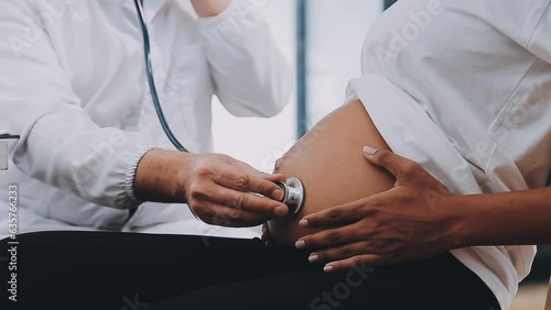 Happy pregnant woman visit gynecologist doctor at hospital or medical clinic for pregnancy consultant. Doctor examine pregnant belly for baby and mother healthcare check up. Gynecology concept. photo