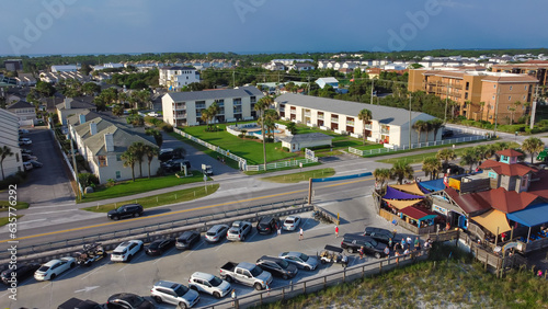 Busy parking lot near row of beach condominium, vacation rentals and restaurant along 98 Scenic Gulf Drive in Walton, Florida, America photo