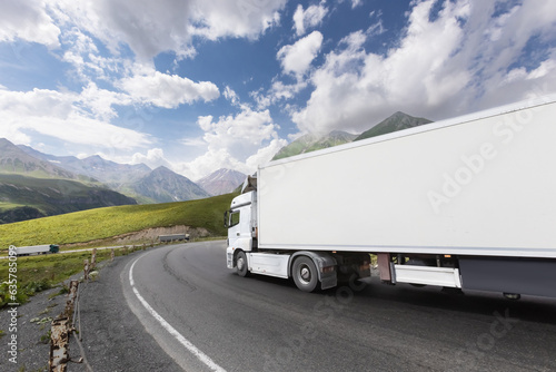 semi truck driving through mountain road pass