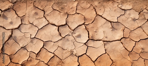 Hot dry cracked soil texture background. Generative AI technology. 