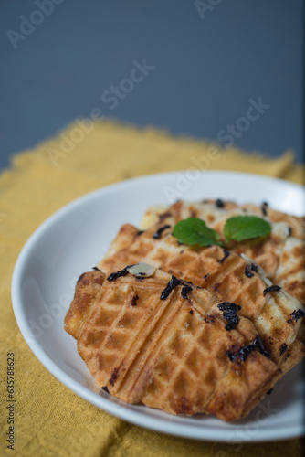 Croissant waffle or croffle on white plate. Croffle is Korean-influenced street food which become popular and trend in Indonesia now-days