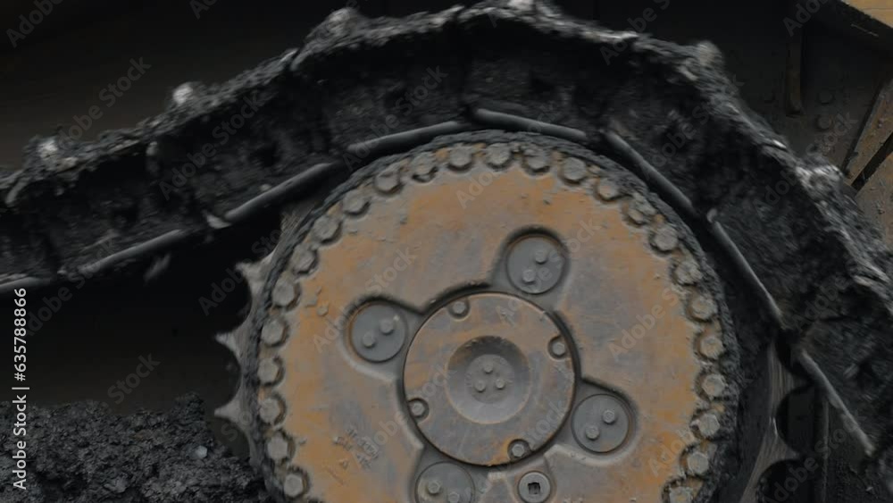 Close Up Of Industrial Excavator Tracks With Rough Dirt Stuck Between Rollers And Chain. Undercarriage Tracks Of Industrial Excavator Machine. Industrial Excavator Vehicle Tracks Moving On Mined Rocks Close Up Of Industrial Excavator Tracks With Rough Dirt Stuck Between Rollers And Chain. Undercarriage Tracks Of Industrial Excavator Machine. Industrial Excavator Vehicle Tracks Moving On Mined Rocks
