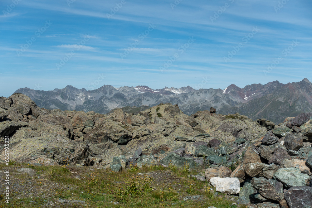 Panoramic view over rocks and stones towards high summits 