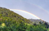 A rainbow in the sky. Mountains background. Selective focus